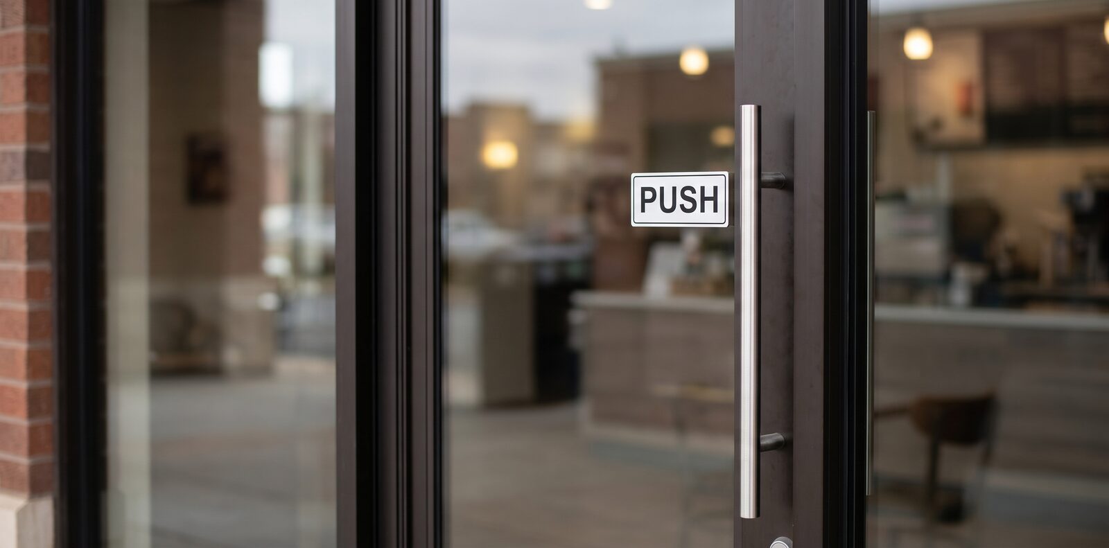 A door with a pull handle and a sign that says PUSH